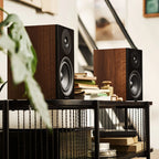 Argon Audio Forus 5 passive bookshelf speakers with wood finish, showing front view with speaker grille and sleek design.