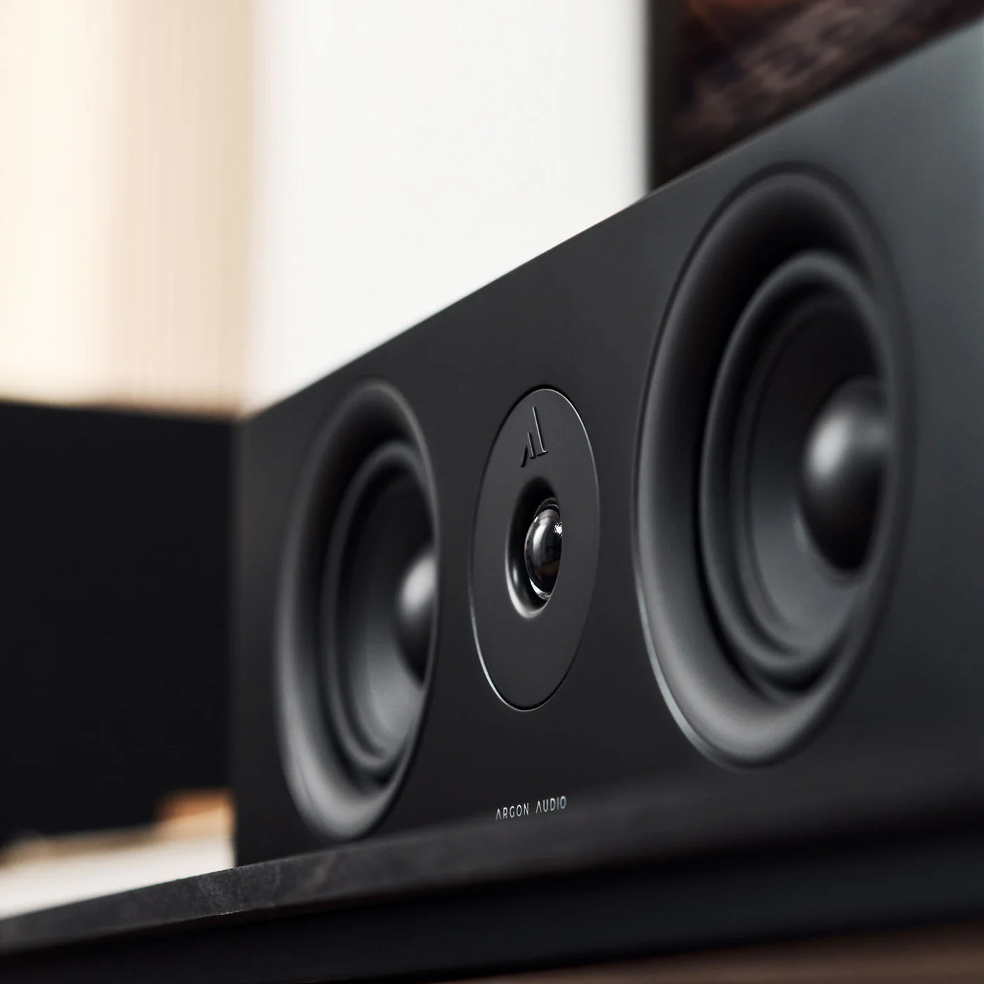 Argon Audio Forus Center speaker in black, showcasing its modern design and front grille for home theater or audio setup.