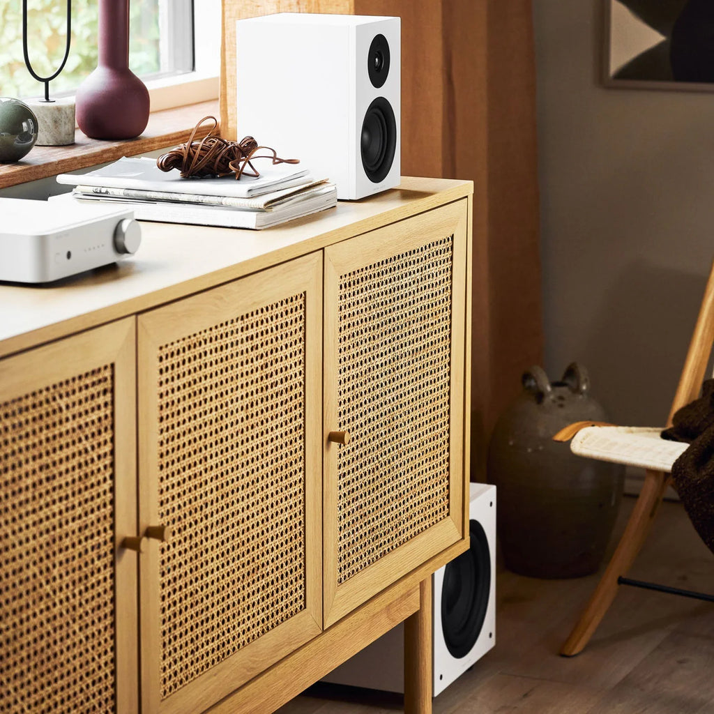 Argon Audio Forus 4 passive bookshelf speakers with white finish, shown from the front with speaker grille and wood cabinet accents.
