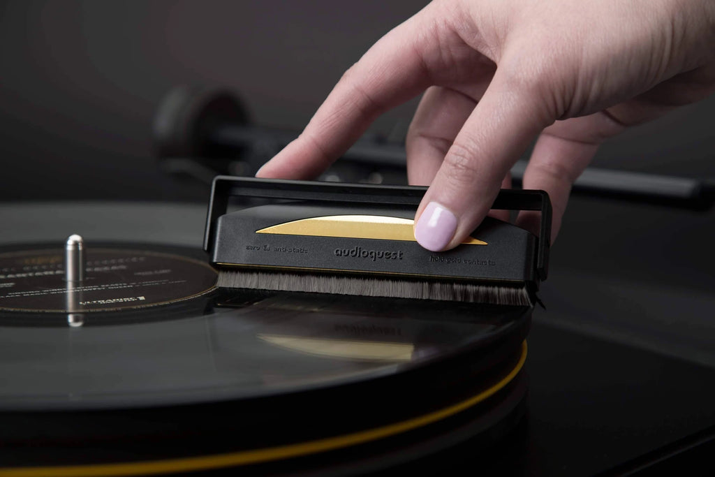 Close-up of the AudioQuest Gold Anti-Static Brush for record cleaning, featuring fine bristles for removing static and dust from vinyl records.