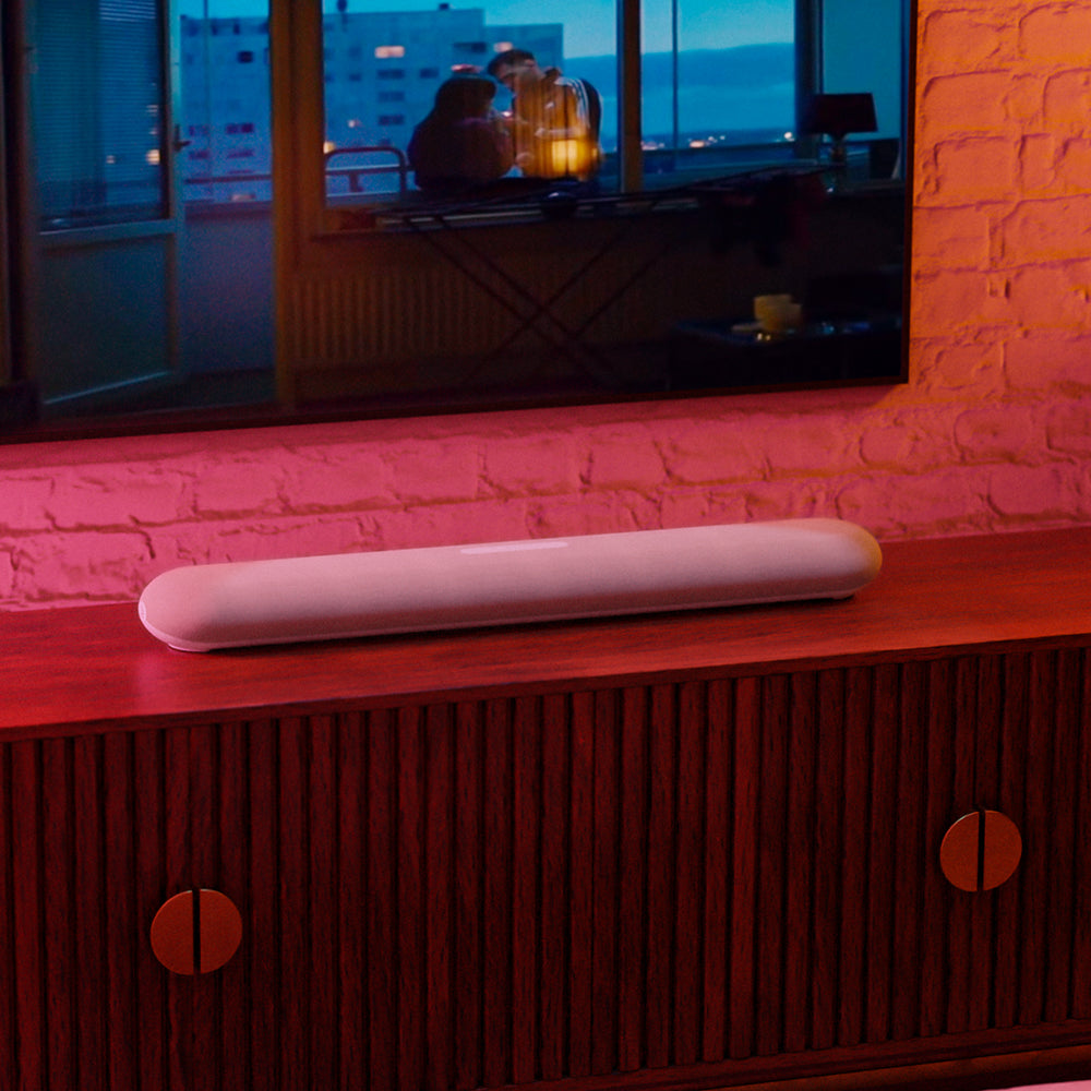 Bluesound Pulse Cinema Mini soundbar with sleek design and multiple speakers, ideal for enhancing TV audio in a modern living room.