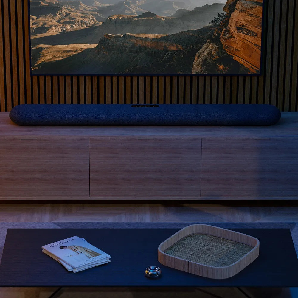 Bluesound Pulse Cinema soundbar and TV speakers setup in a modern living room, showcasing sleek design and premium audio quality.