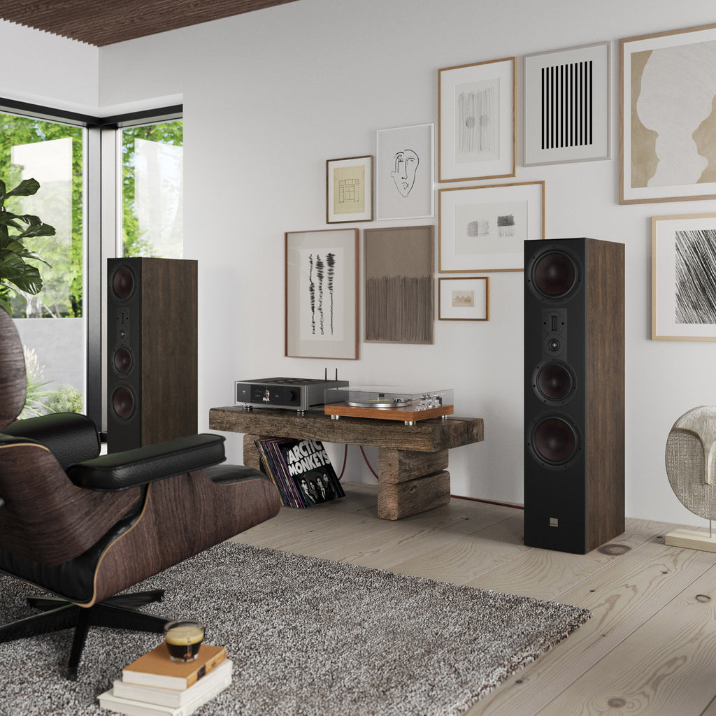 DALI Opticon 8 MK2 passive floorstanding speakers shown in a stylish living room setting, highlighting their sleek design and wood finish.