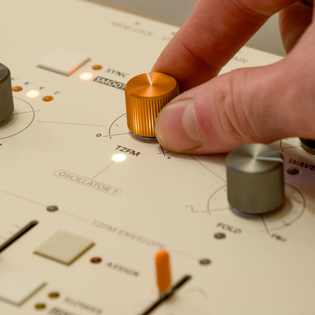 Frap Tools Magnolia keyboard synthesizer with sleek black design and various control knobs and buttons on top panel.