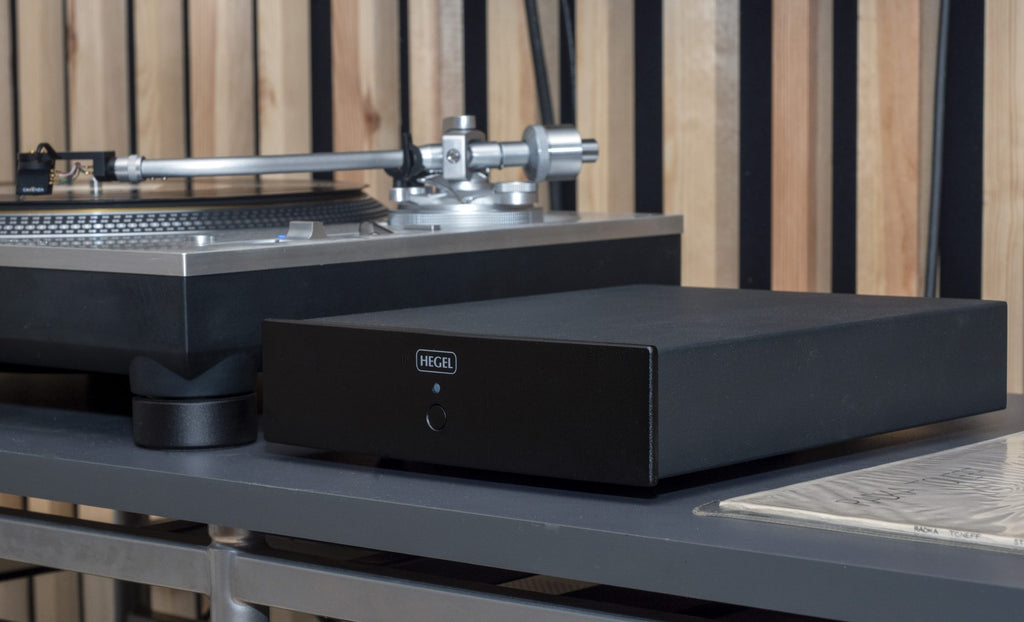 Hegel V10 phono preamp with sleek black finish and control knobs, designed for high-quality audio signal amplification.