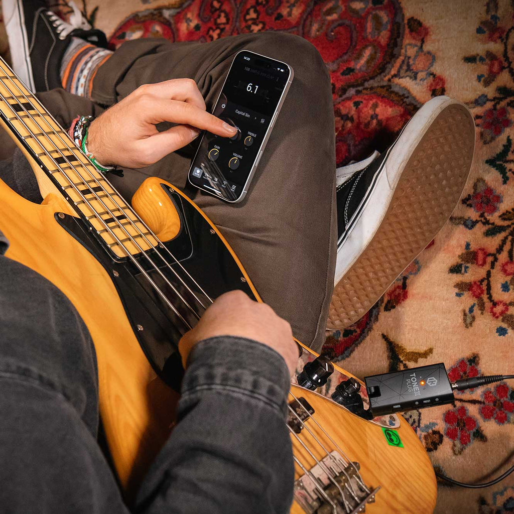IK Multimedia Tonex Plug interface showing software dashboard with audio controls and virtual guitar amp presets.