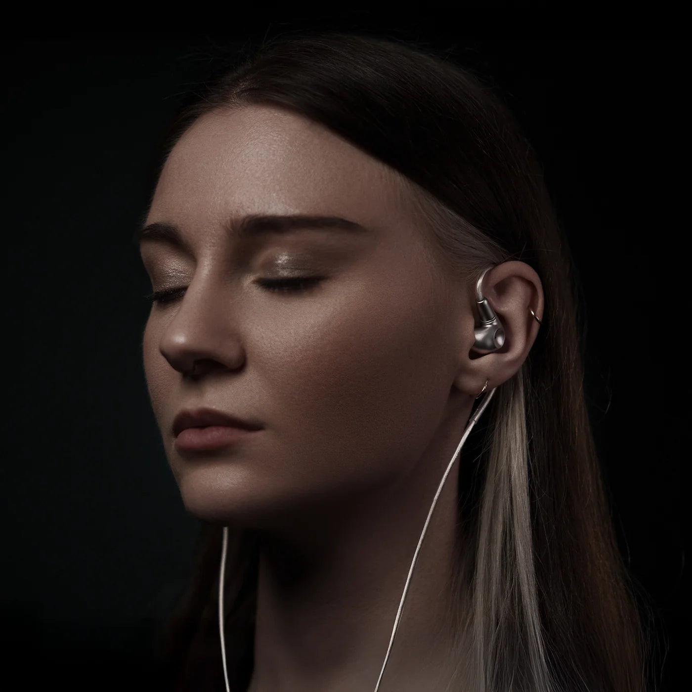 Meze Audio Astru wired in-ear monitor headphones with black earbuds and sleek design.