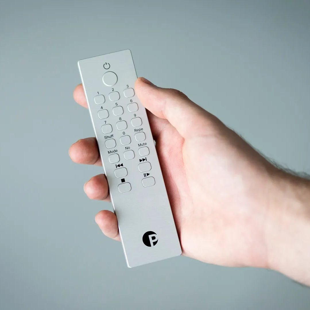 Pro-Ject CD Box RS2 Tube CD player with remote control, featuring sleek design and high-quality audio components.