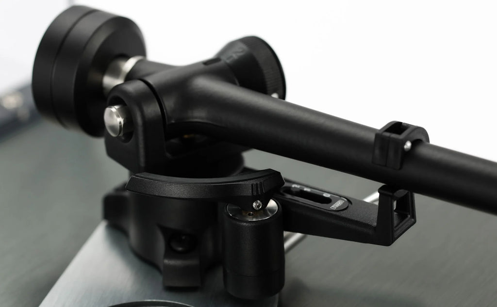 Close-up of Rega Planar 3 RS turntable with aluminum platter and Nd5 cartridge, showing detailed bias housing.