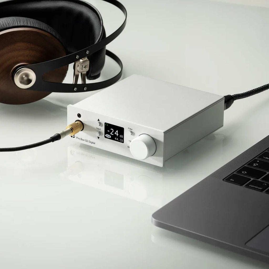 Pro-Ject Pre Box S2 Digital Edition 23 headphone amplifier and DAC with sleek black design and various input ports.