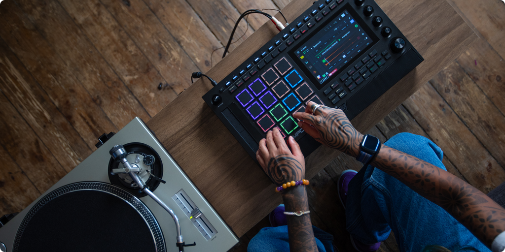 Akai Professional MPC Live III drum machine and sampler with touchscreen and portable design, displayed on a sleek black background.