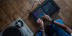 Akai Professional MPC Live III drum machine and sampler with touchscreen and portable design, displayed on a sleek black background.