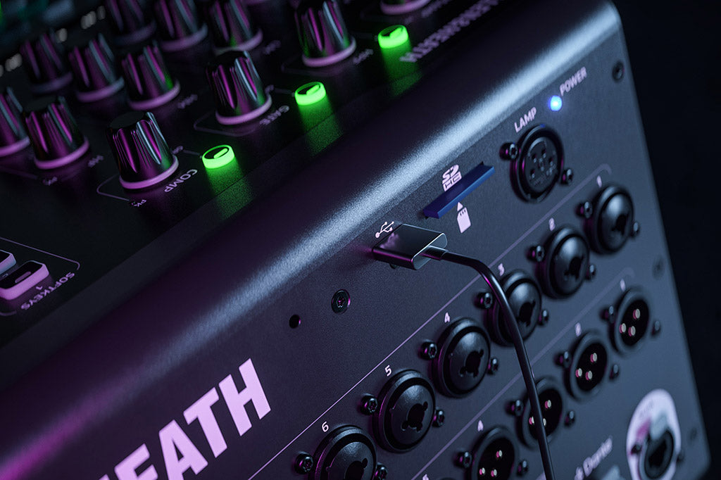 Allen & Heath Qu-6 digital mixer with USB-C and SD card slots, showing a professional audio mixing console with control knobs and LCD screen.