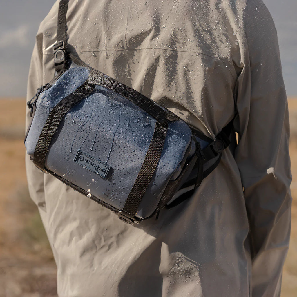 Wandrd Rogue Sling video equipment bag in Aegean Blue, showing its compact design and adjustable strap.