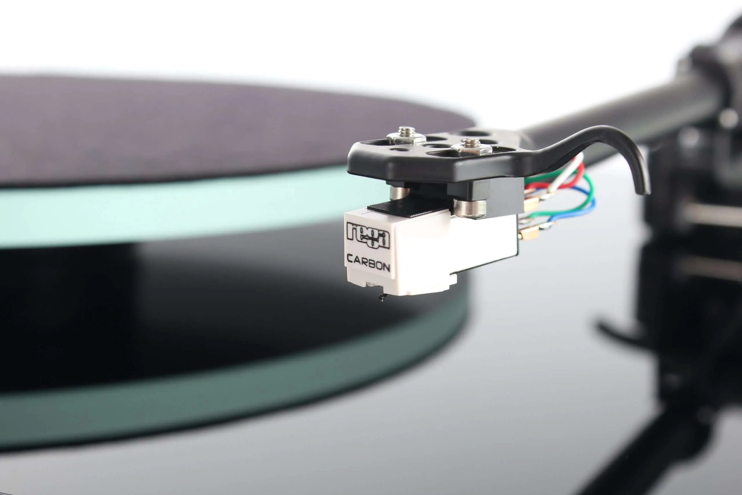 Rega Planar 2 turntable with Nd3 cartridge, showcasing its sleek design and tonearm in a close-up view.