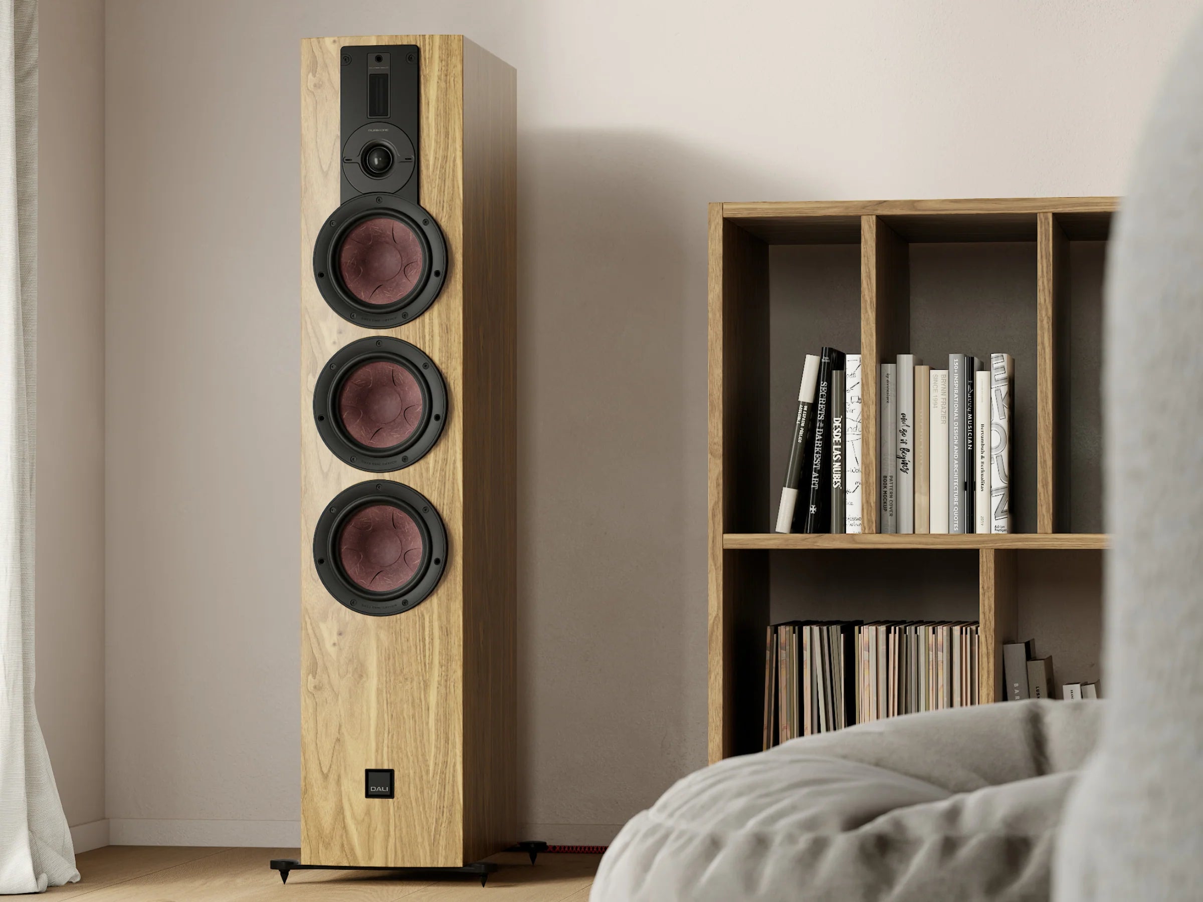 DALI Rubikore 8 passive floorstanding speakers shown in a modern living room setup with sleek wood finish and fabric grilles.