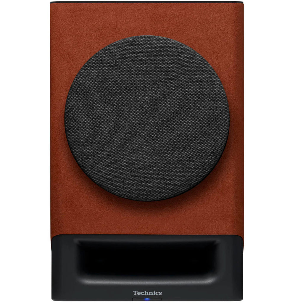Technics SC-CX700 active bookshelf speakers with terracotta front cover, showcasing sleek design and speaker grille.