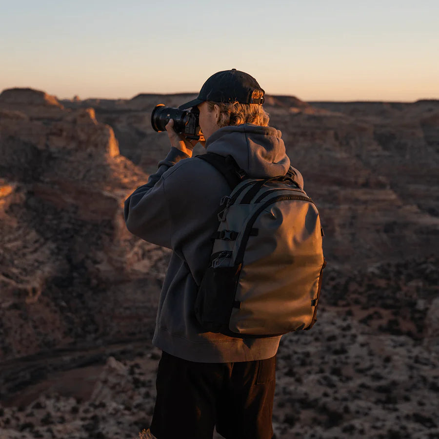Wandrd Stratus Photo 18L green video equipment bag with padded compartments and adjustable straps for gear protection.