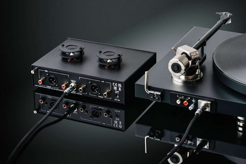 Pro-Ject Tube Box S3 B phono preamp with vacuum tubes, compact black design, featuring input and output connections for audio enhancement.