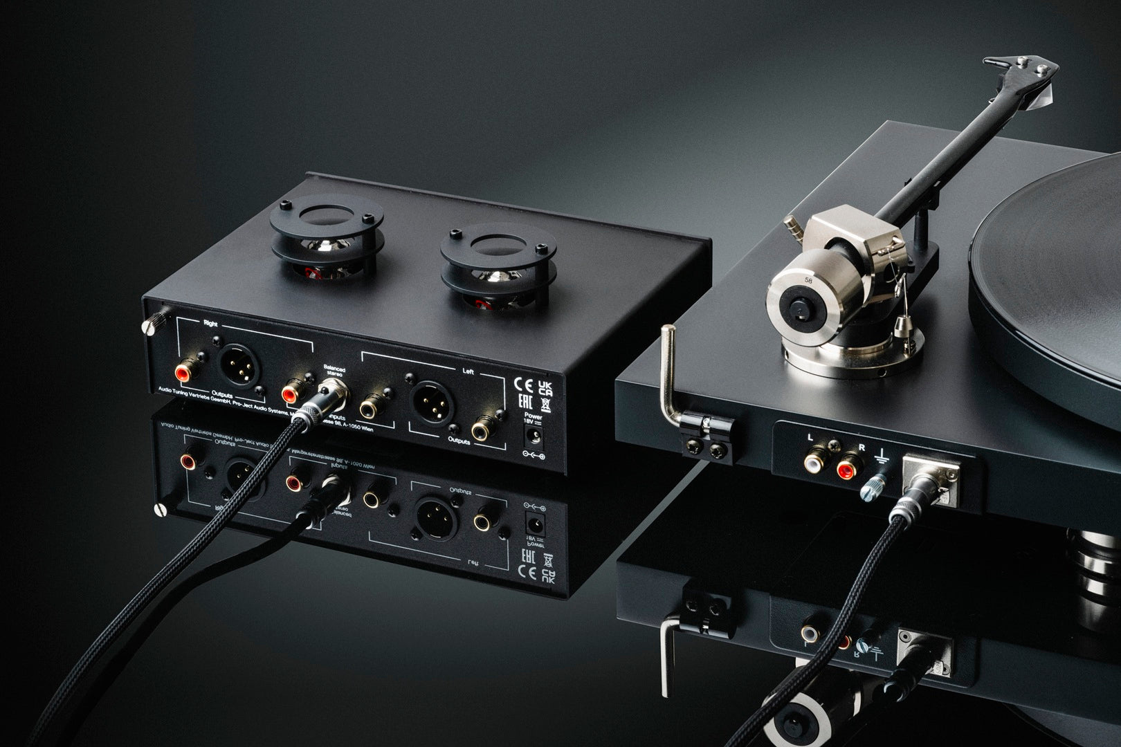 Pro-Ject Tube Box S3 B phono preamp with vacuum tubes, compact black design, featuring input and output connections for audio enhancement.