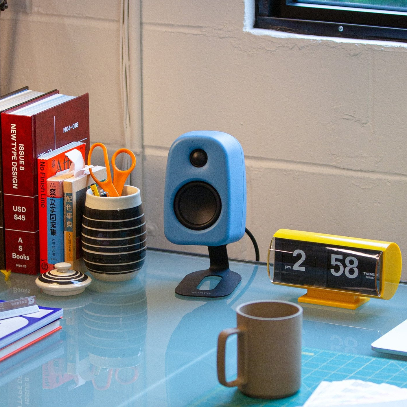 Kanto Audio UKI desktop speakers with sleek design, shown in cropped view, featuring black finishes and modern speaker grille.