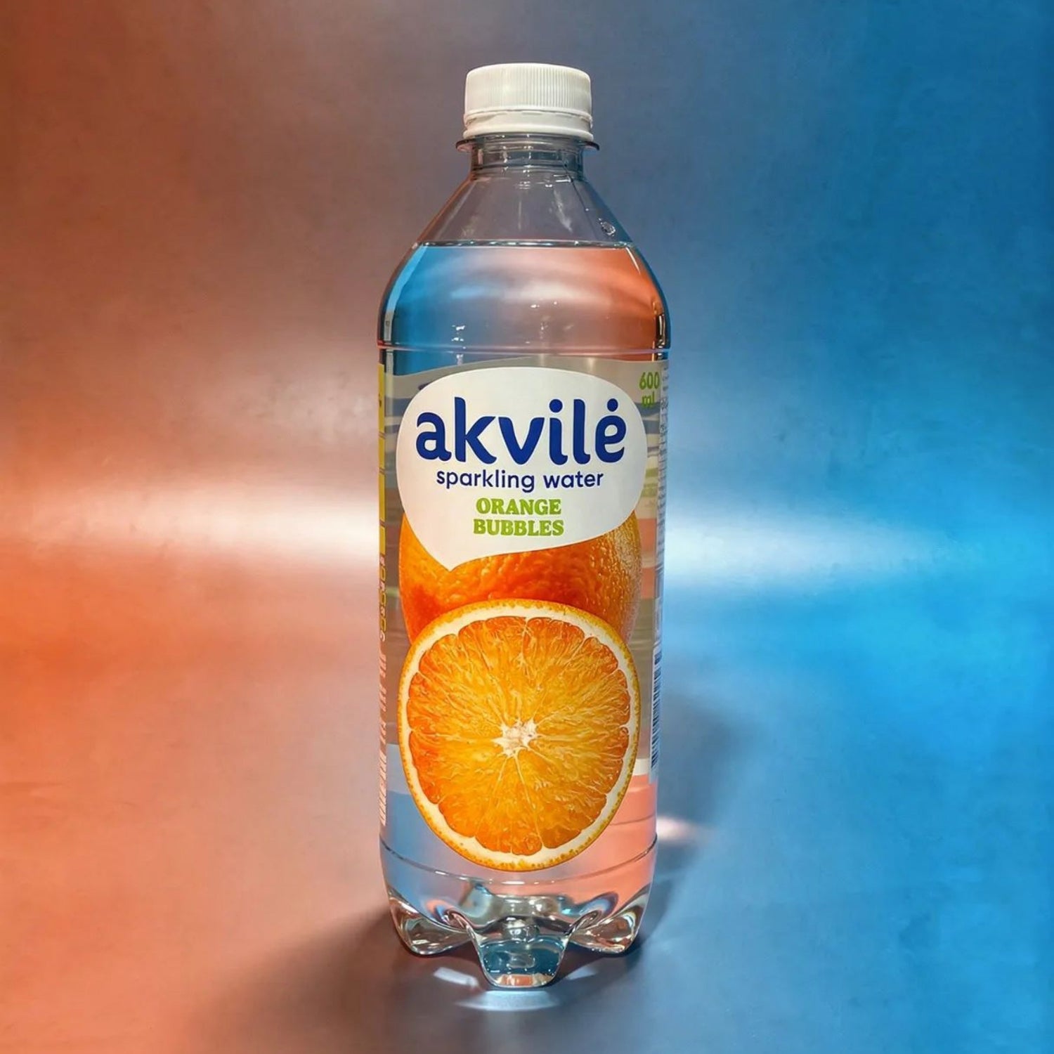 Bottle of akvile sparkling water with an orange slice on a gradient background