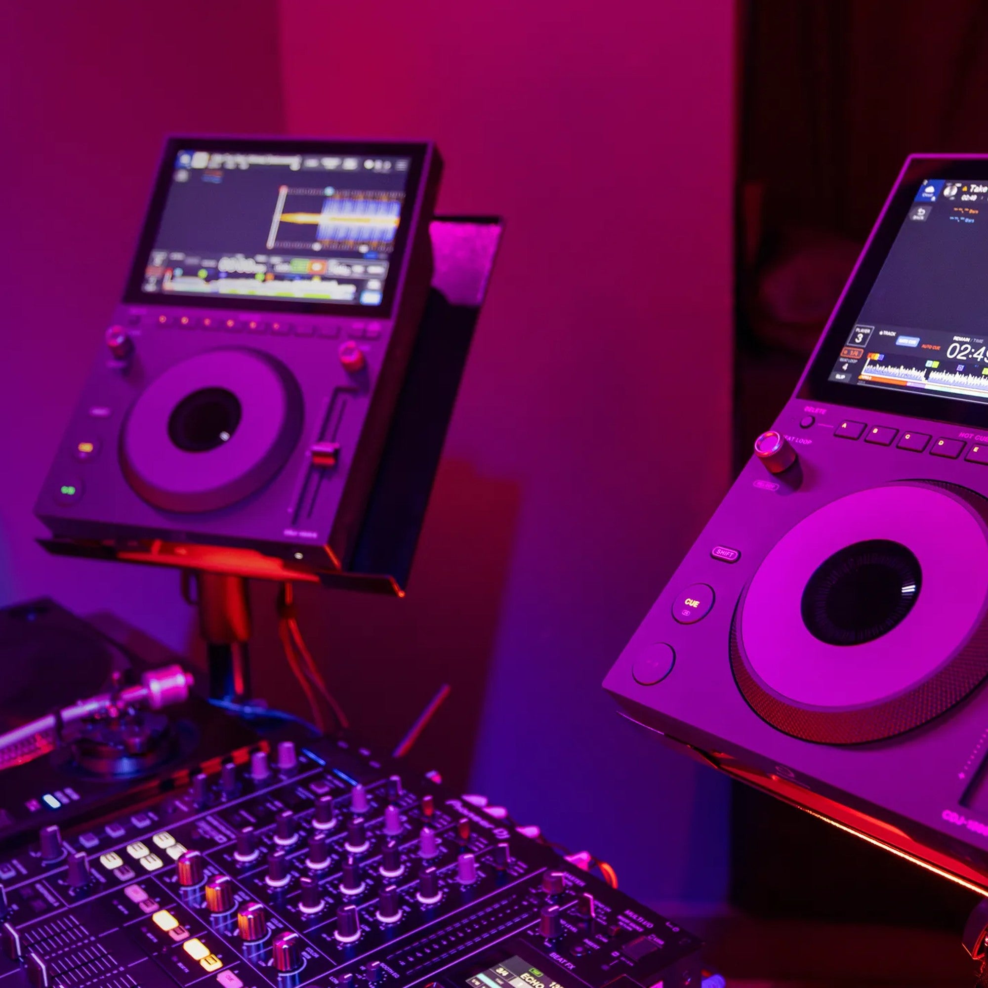 AlphaTheta CDJ-1500X players in a club DJ booth