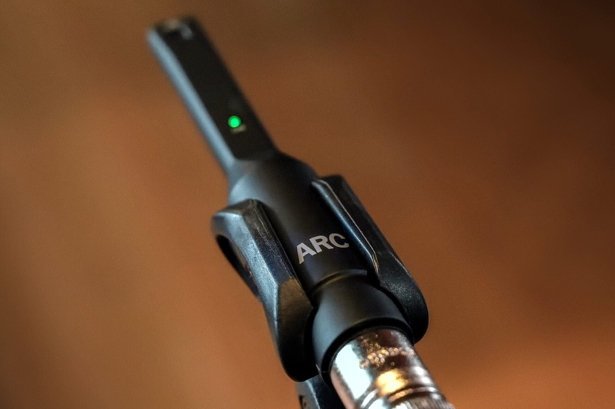 IK Multimedia ARC X room calibration software with measurement microphone, used for acoustic room analysis and calibration.