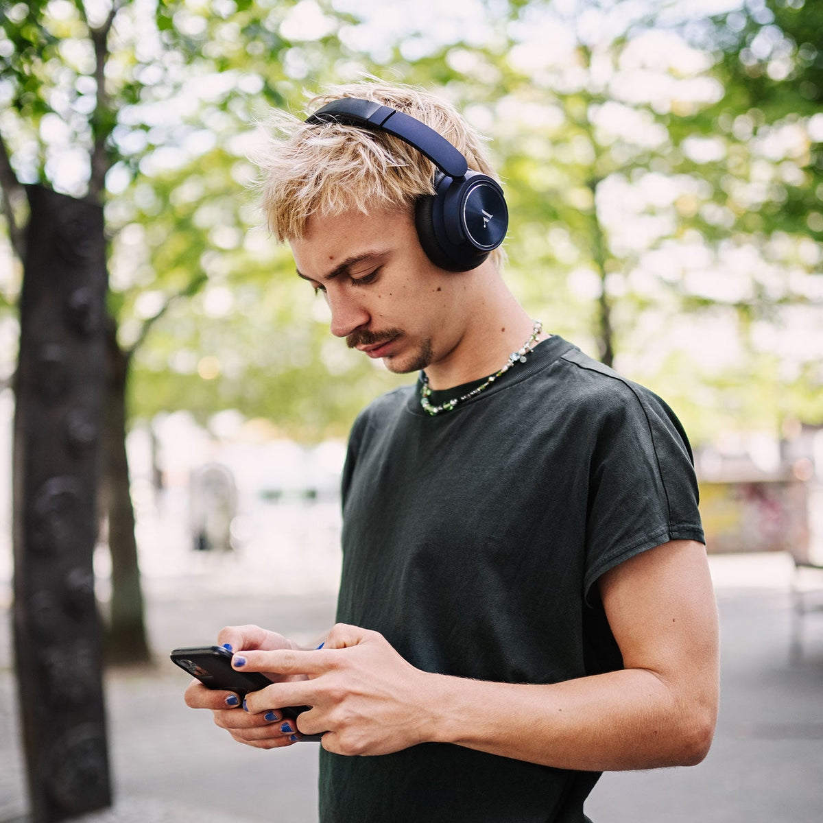 Argon Audio Quiet Storm Blue worn while using a phone