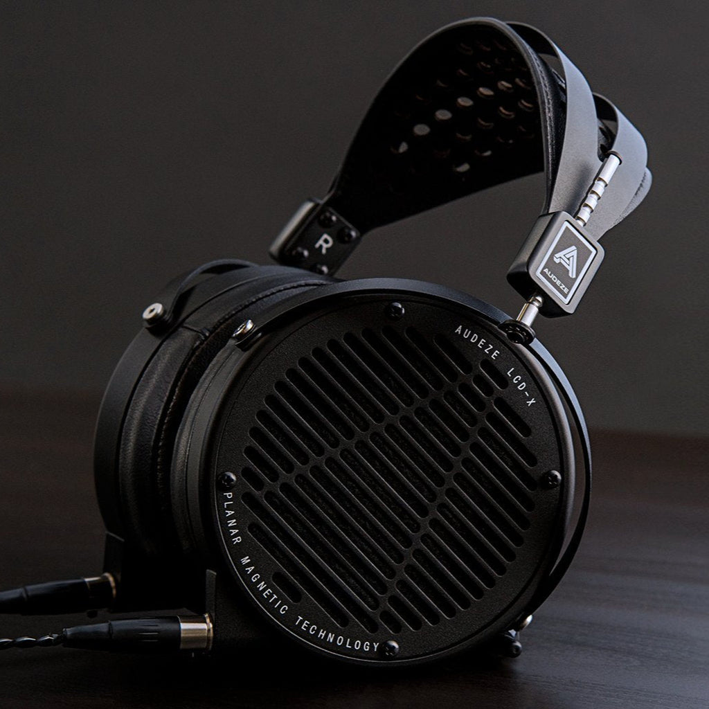 Audeze LCD-X Creator Package studio headphones with leather-free ear cups, featuring a sleek black design and open-back ear cups.