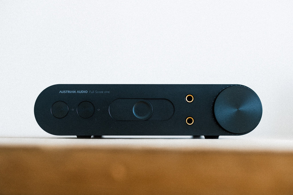 Austrian Audio Full Score One headphone amplifier and DAC with sleek black design and control knobs on top.