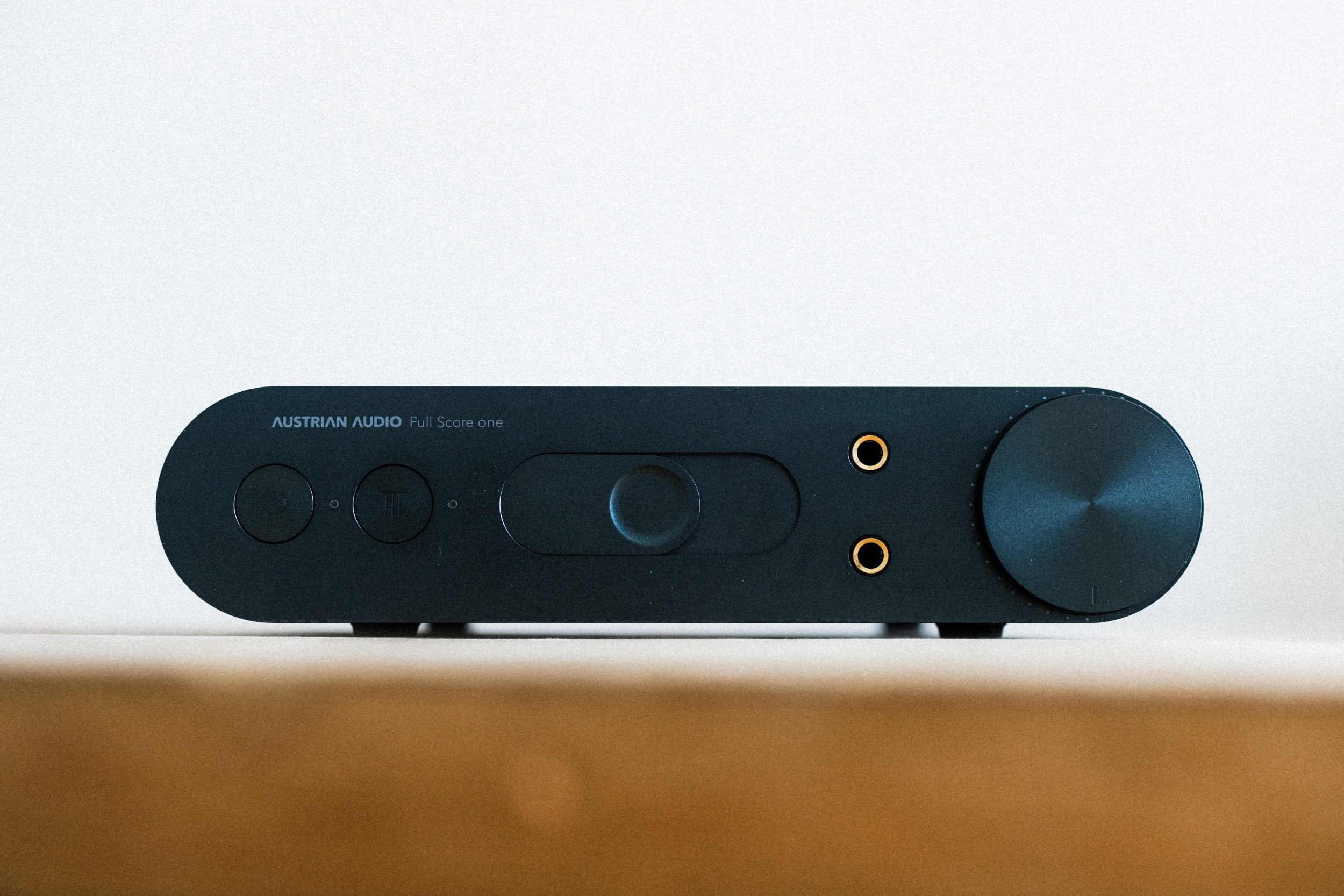 Austrian Audio Full Score One headphone amplifier and DAC with sleek black design and control knobs on top.