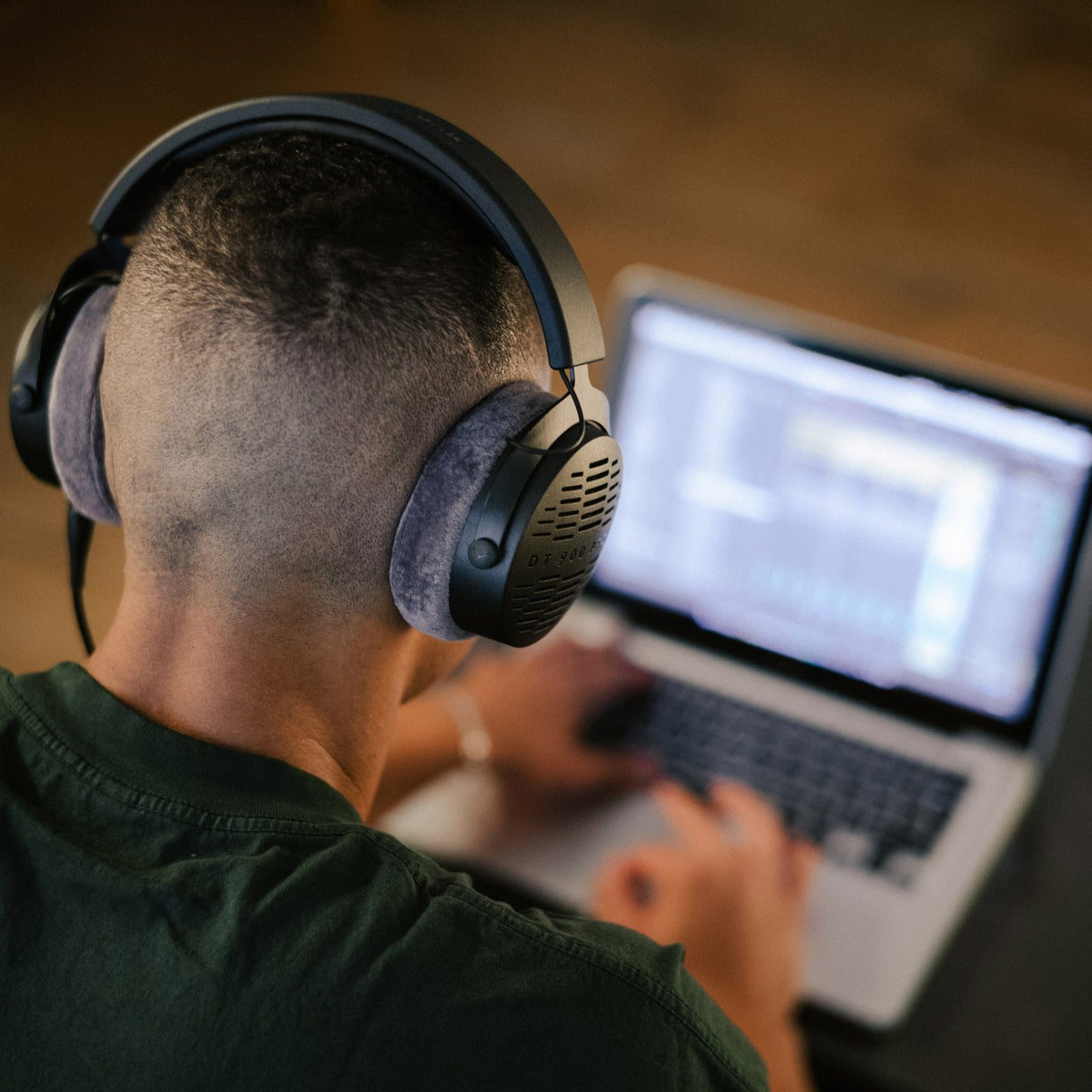Producer wearing Beyerdynamic DT 900 Pro X connected by the Pro X USB-C Cable to a laptop
