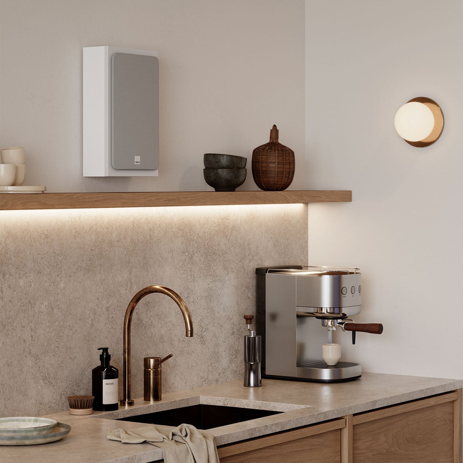 DALI Sonik On-Wall in-wall and outdoor speaker with sleek design, mounted on a wall, showcasing modern audio equipment.