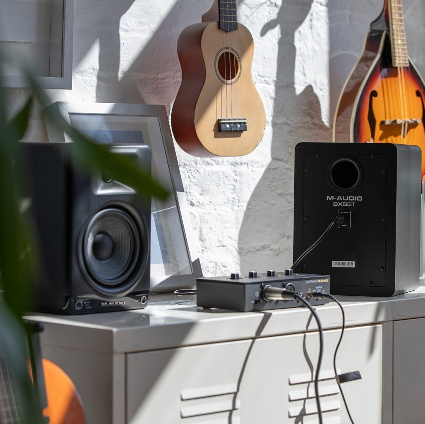 M-Audio BX5 BT active nearfield monitors with sleek black design and front-facing controls for professional audio listening.