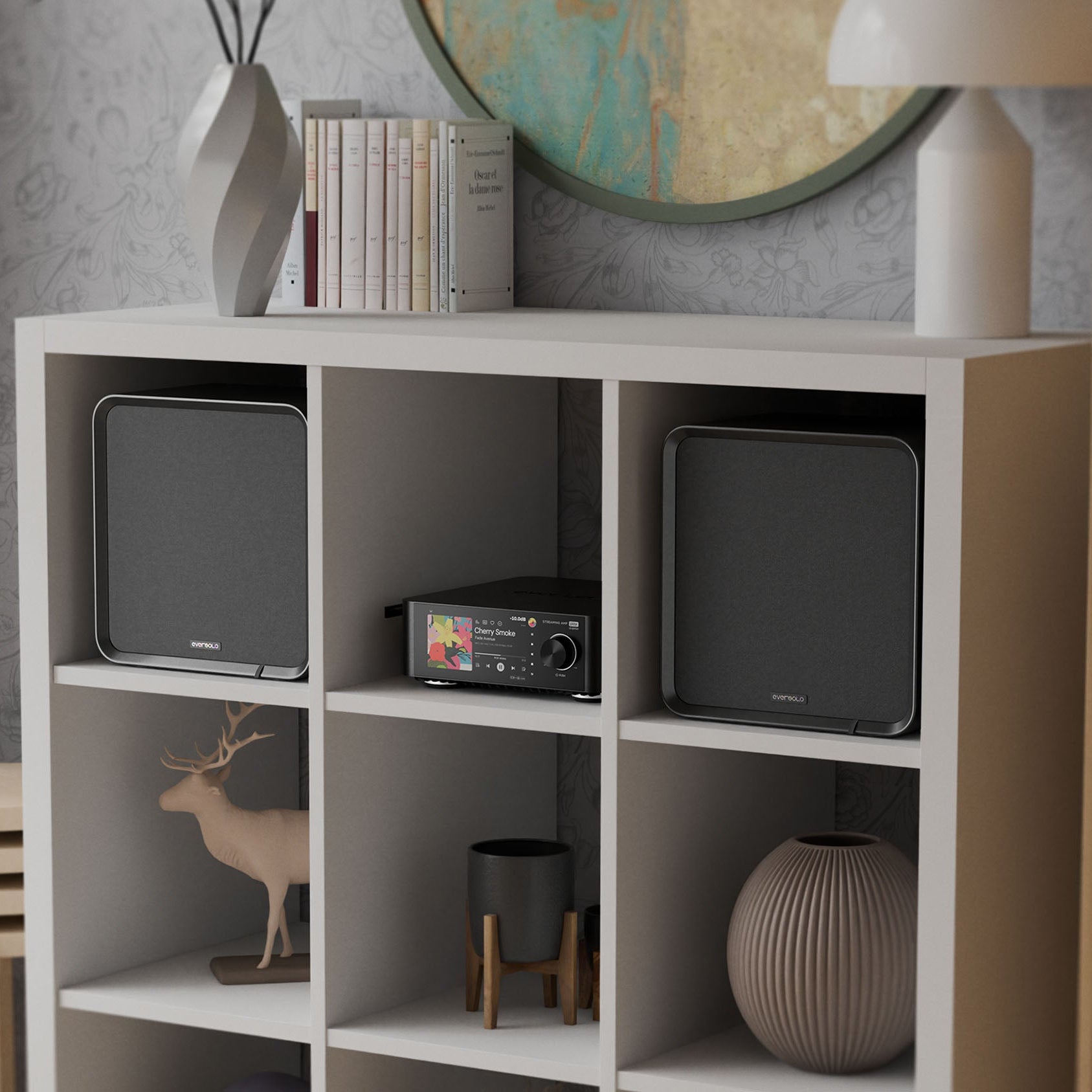 Eversolo SE100 passive bookshelf speakers shown in a modern home audio setup with wood finish speakers on stands.