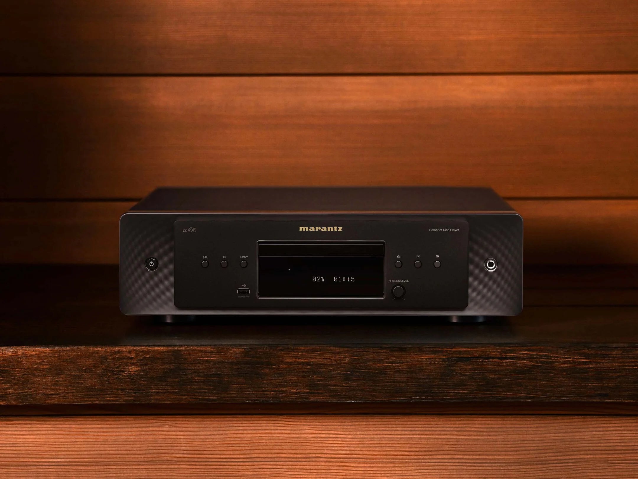 Marantz CD 60 black CD player with sleek design, showing top view and front display on a studio surface.