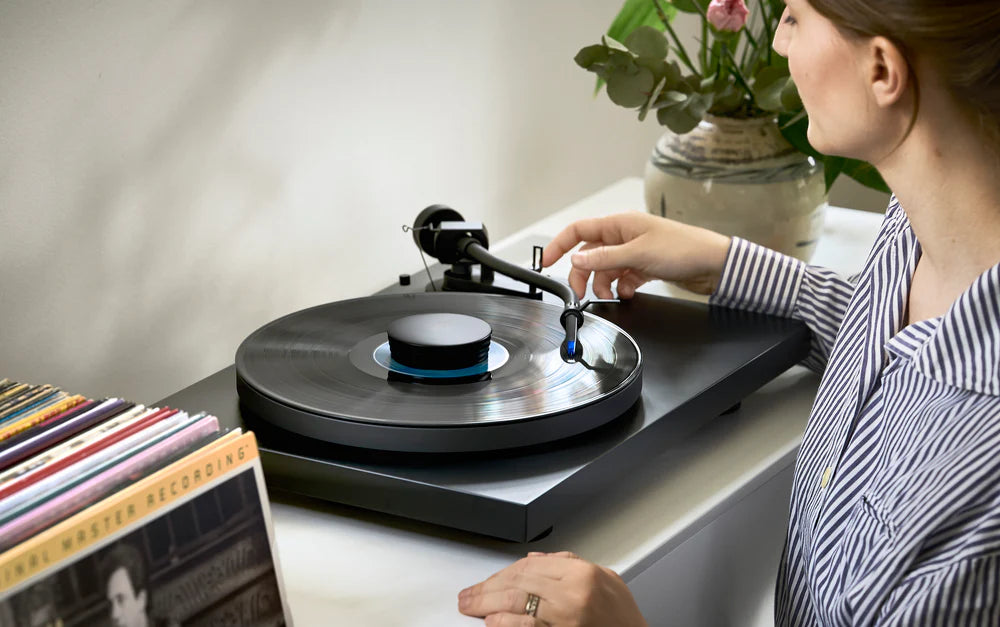 Ortofon Concorde Music Blue turntable cartridge mounted on a Pro-Ject turntable, showcasing its sleek design and stylus.