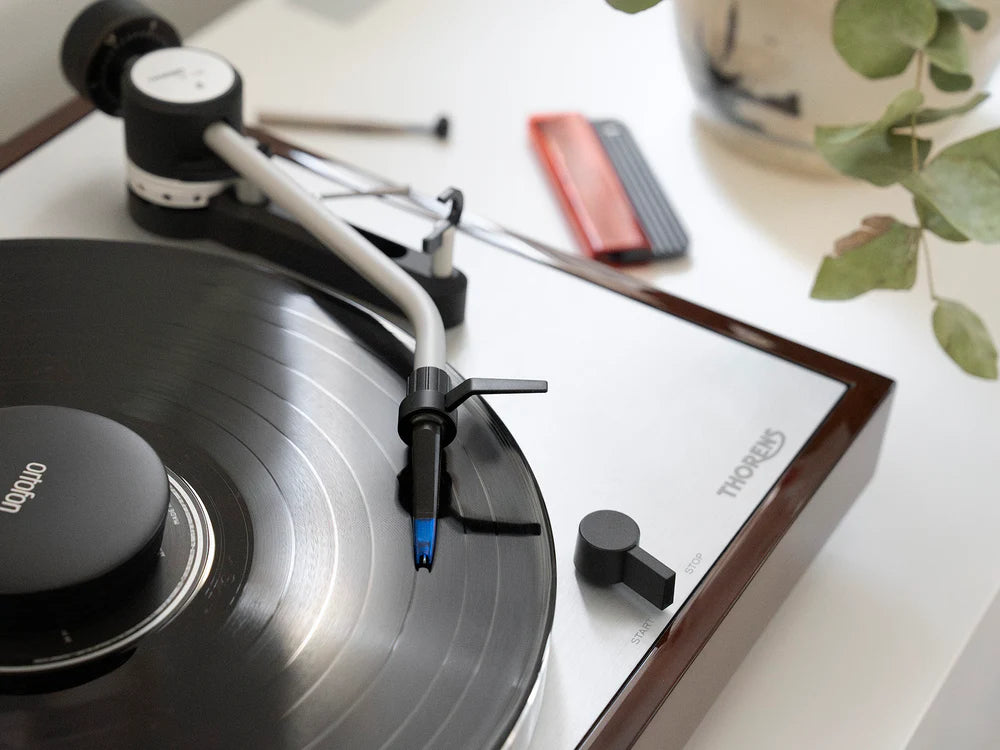 Ortofon Concorde Music Blue turntable cartridge mounted on Thorens turntable, showcasing its sleek design and stylus details.