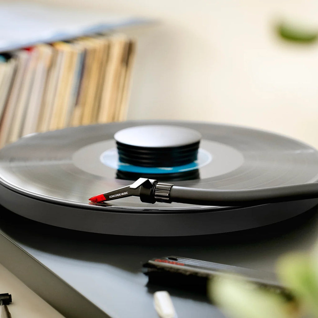 Ortofon Concorde Music Red turntable cartridge mounted on a Pro-Ject turntable, close-up of the cartridge and tonearm.