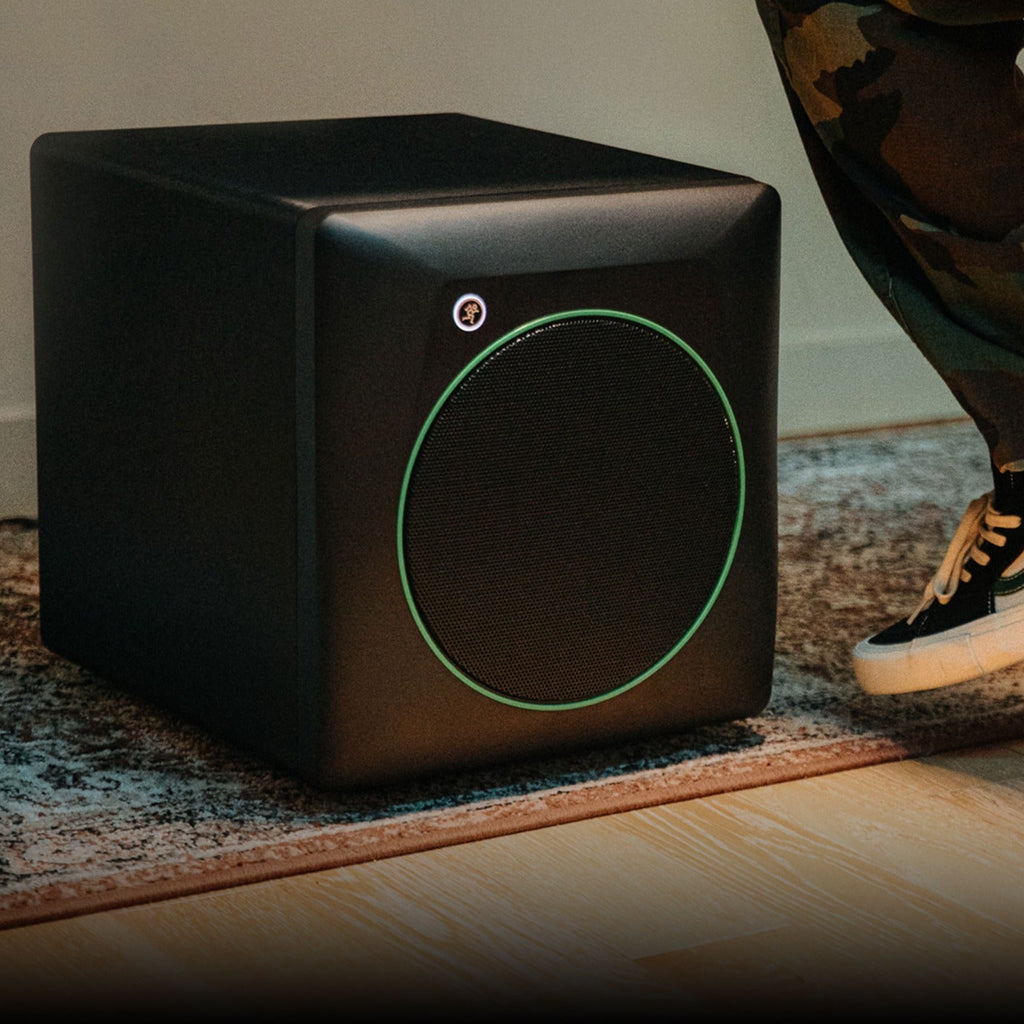 Mackie CR8SBT subwoofer with sleek black enclosure and control panel, designed for professional audio monitoring on a desktop setup.