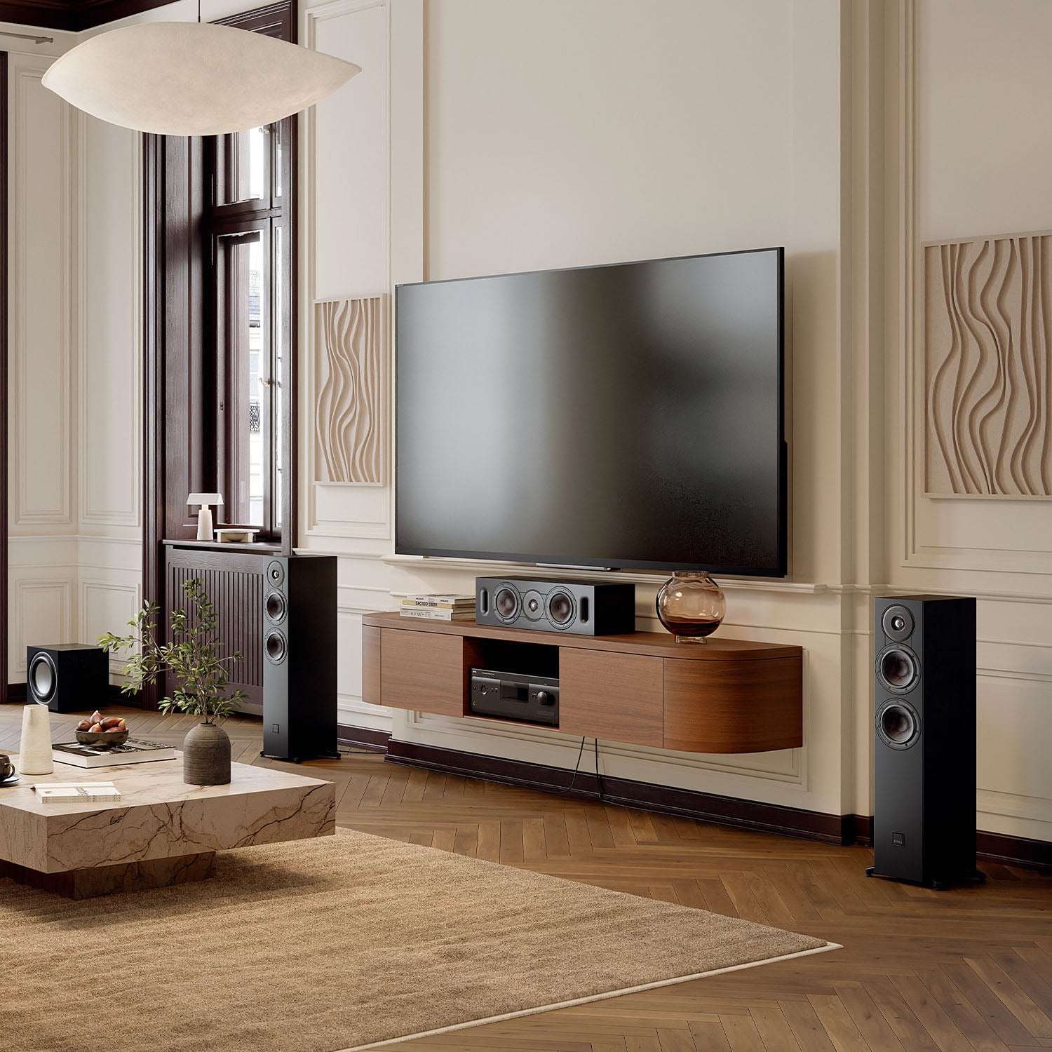 DALI Sonik Cinema center speaker with sleek black design, featuring multiple drivers for clear dialogue and immersive sound.