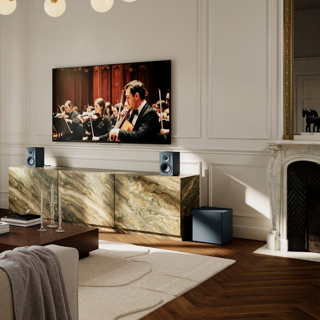 Dali Basik Sub in Chilly Blue under a marble console in a classic living room