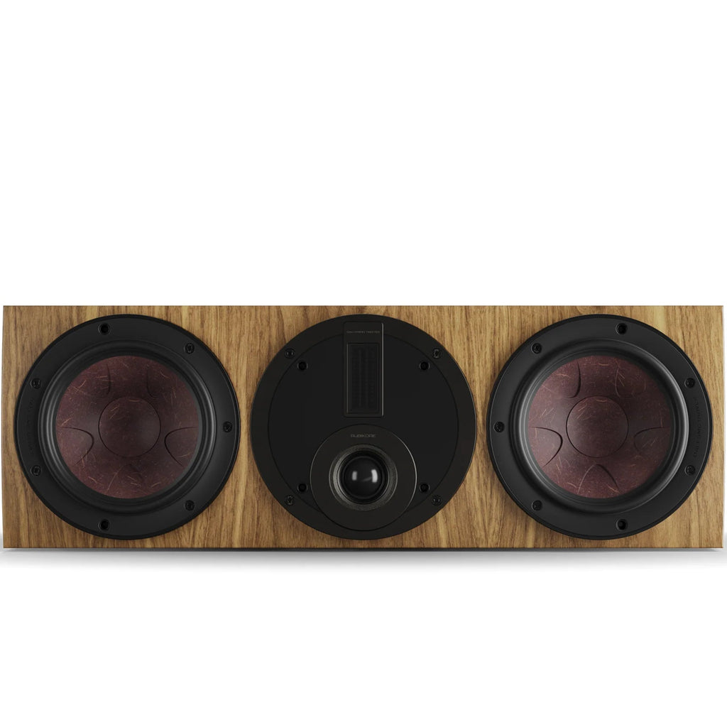 DALI Rubikore Cinema center speaker in natural walnut finish, showcasing the sleek design and wood grain details.