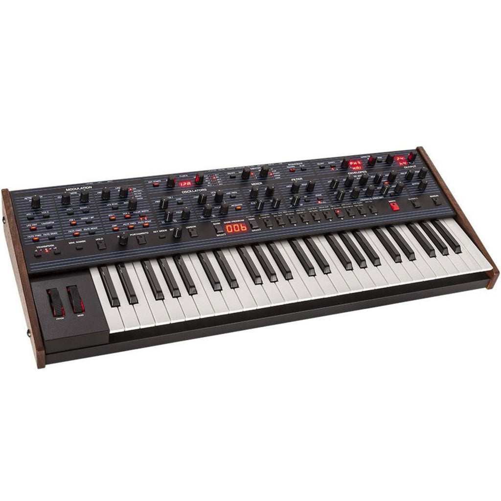 Sequential OB-6 synthesizer by Dave Smith Instruments with control knobs and keyboard in a studio setting.