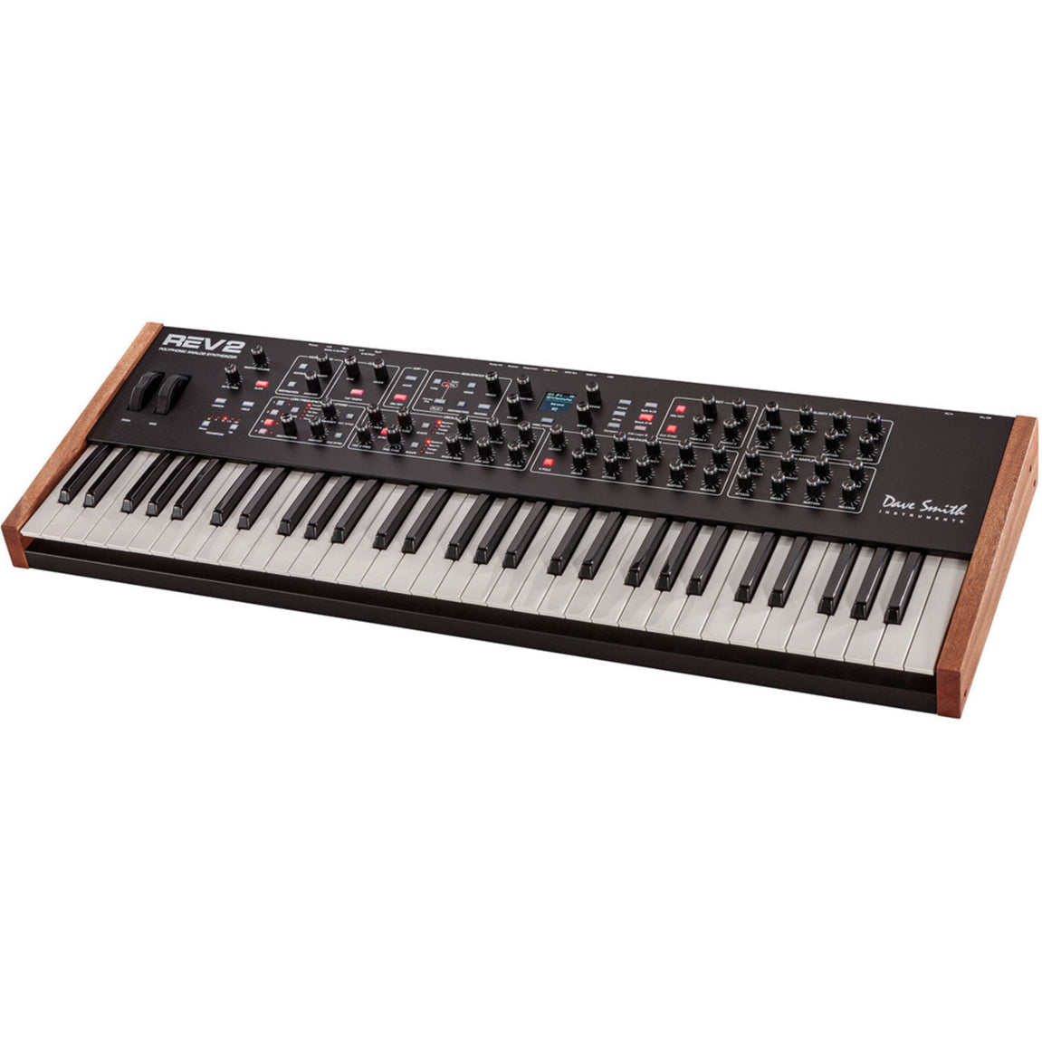 Sequential Prophet Rev2-16 synthesizer with 16-voice keyboard and control knobs, displayed on a music studio desk.