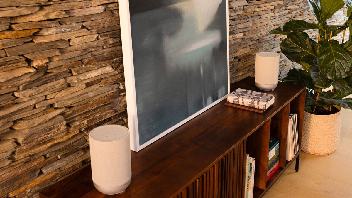 Denon Home 200 wireless speakers on a sideboard