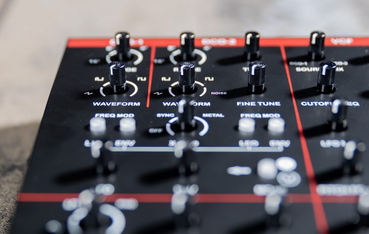 Dtronics DT-200 V3 synthesizer with control knobs and display screen, showcasing its compact electronic music instrument design.