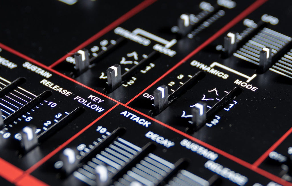 Dtronics DT-800 synthesizer with various knobs and buttons, featuring a sleek black design and detailed control panel.