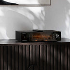 Eversolo DMP-A8 Master Edition Gen 2 on a dark wood sideboard with VU meters lit